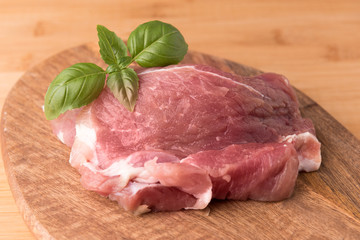 raw pork on a board made of mango tree