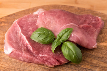 raw pork on a board made of mango tree