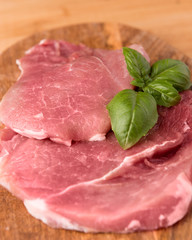 raw pork on a board made of mango tree