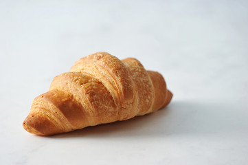 fresh croissant on white marble