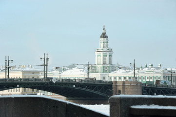 Fototapeta na wymiar Kunstkamera building and view of Palace bridge in winter