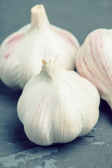 Fresh garlic on the wooden background. Selective focus.
