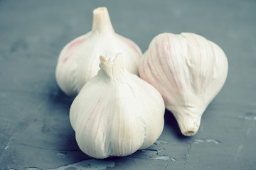 Fresh garlic on the wooden background. Selective focus.