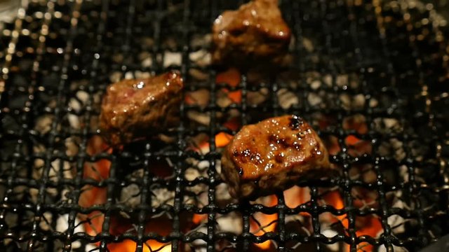 Slow motion Grilled Barbecue Beef Steak cooked in a Japanese restaurant in Tokyo, Japan grilling beef Yakiniku style