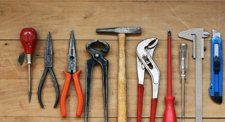 Construction tools on a rustic wood background