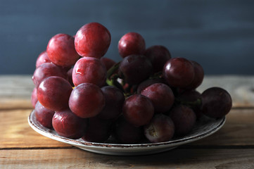 bunch of red grapes on plate