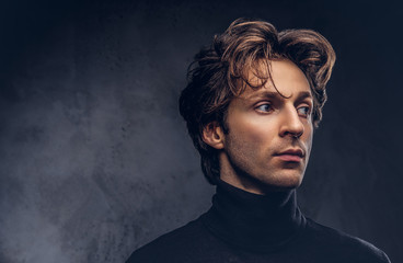 Portrait of a charismatic sensual male in black sweater. Creativ