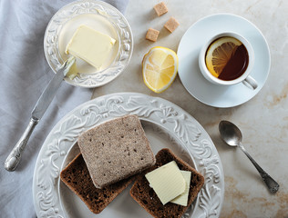 simple Breakfast - lemon tea and rye bread with butter
