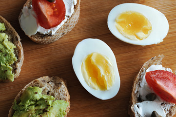 canape sandwiches on a wooden Board