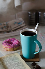 Black coffee with berry doughnut