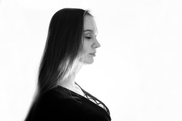 Studio shot of side view brunette girl at white background.