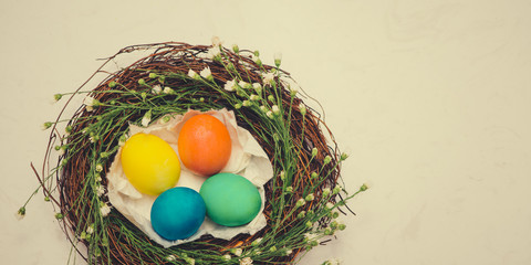 Fototapeta na wymiar Banner. Easter eggs in beautiful nest on marble background.