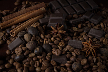 Black Chocolate, Spices, Coffee Grain on a Wooden Background