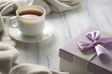 Cup with Coffee, Gift on the White Wooden Table. Concept of Spring