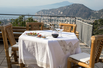 Prepared for supper table on the terrace overlooking the Bay of Naples and  Vesuvius. Sorrento. Italy
