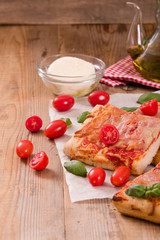 Italian pizza with cheese, tomatoes and fresh basil. 