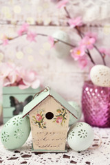 easter decoration with vintage style bird feeder and eggs