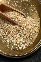 Raw quinoa seeds  on wood spoon closeup
