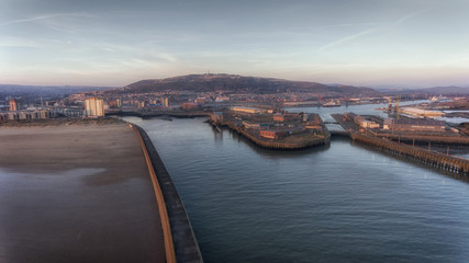 Obraz premium Editorial Swansea, UK - February 24, 2018: The west and east piers and mouth of the river Tawe at the entrance to the docks at Swansea city UK