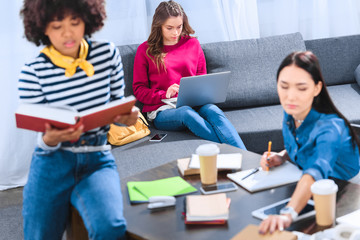 multicultural group of young students studying together