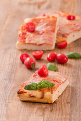 Italian pizza with cheese, tomatoes and fresh basil. 