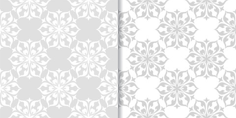 Light gray floral backgrounds. Set of seamless patterns