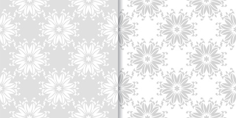 Light gray floral ornaments. Set of seamless patterns