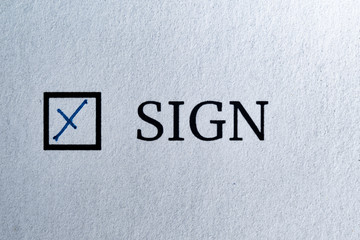Questionnaire. Blue pen ink and the inscription SIGN with cross on the white paper