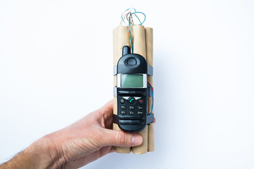 The hand holds the bomb with control over the cell phone.
