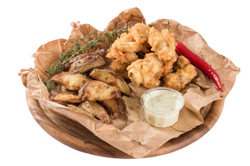 British Traditional Fish and chips served on crumpled paper.