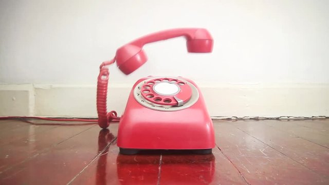 vintage phone ringing of the hook on old wooden floor