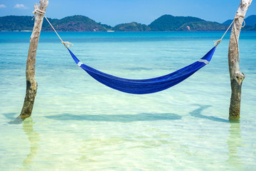 Blue hammock on tropical beach for summer and vacation