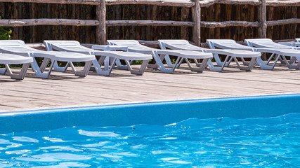 Deckchairs for sunbathing near the swimming pool