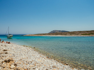 Fototapeta premium Astypalaia,Greece-August 2016.Small boats like this, can take you on isolated beaches where the waters are crystal clear