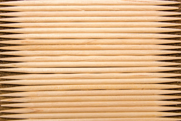 many toothpicks on the brown table background

