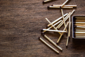 Matches in box, dark background. Close-up shot. Matches in open match-box on carton underlay