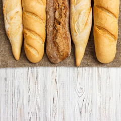 Assortment of fresh French baguettes on a wooden table
