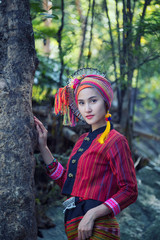 Beautiful Asian woman with karen traditional dress explore in forest during her summer vacation in...