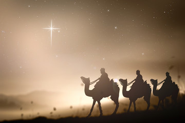 Christmas religious nativity concept: Prophecy magi and his friend with three camel on desert was going to bethlehem city in christmas eve.