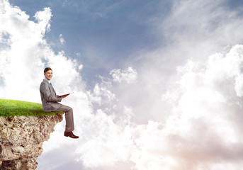 Student guy in suit with book in hands preparing for exam