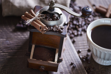 Close up of coffee grinder with ground coffee