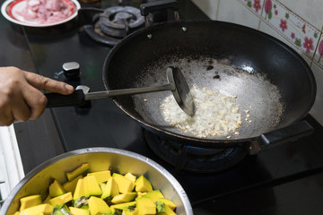 Fry the garlic and stir-fry made in the kitchen. In order to cook Stir Fried pumpkin with pork.Which contains ingredients such as vegetables and meat. Food of Thailand people like to eat.