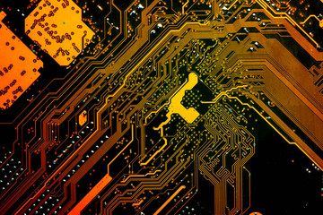 Close up of a printed golden yellow computer circuit board