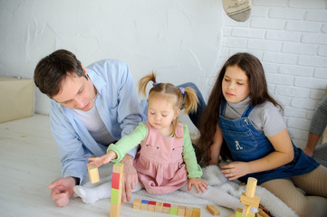 Obraz premium Father plays with two daughters.