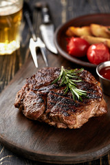 Juicy steak medium rare beef with spices on wooden board on table