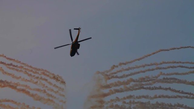 Military helicopter doing stealth evasive maneuvers, anti missile flares launched