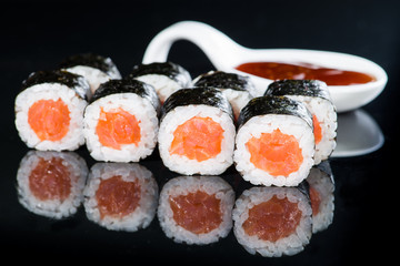 Fresh delicious Japanese sushi with salmon on dark background