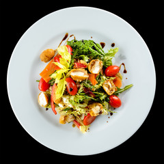Italian food. Delicious salad with cheese mozzarella and fresh tomatoes on dark background. Top view, flat lay