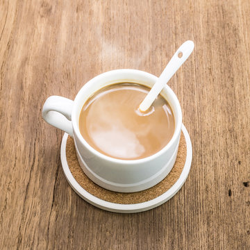 Coffee Mug And Beverage Coaster On Wooden Background.