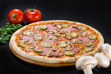Delicious hot Mushroom Pizza with mozzarella, beef, champigon, pepper and sauce on wooden round board on dark background